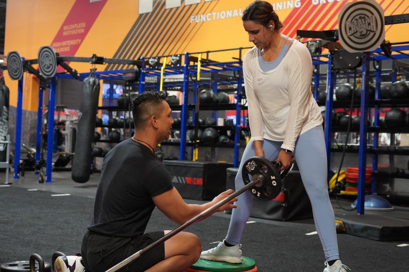 Kevin kneeling beside a client during a hands-on training session